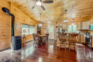 a kitchen with wooden walls and a table and chairs at Secluded Haven - Entire House in Wevertown