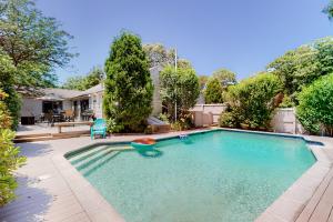 a swimming pool in the backyard of a house at Mews Village Villa in Mashpee