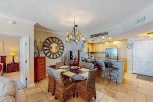 a kitchen and living room with a table and chairs at Portofino Island Resort and Spa Tower 1 608 in Pensacola Beach
