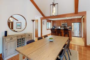 a dining room and kitchen with a table and a mirror at Mews Village Villa in Mashpee