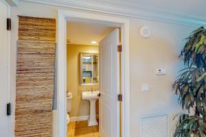 a bathroom with a sink and a mirror at Portofino Island Resort and Spa Tower 1 608 in Pensacola Beach +7 photos