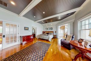 a bedroom with a bed and a desk and a table at The Bonnieview in Nameloc Heights