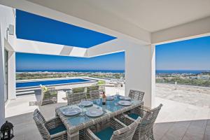 a dining room with a view of the ocean at Villa Marilia in Protaras