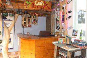 a room with a desk and a laptop on a table at Starlight Inn in Sigchos