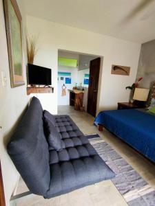 a living room with a couch and a bed at Villa Ensueño, Lagoon Private Front in Bacalar