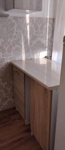 a kitchen with a wooden counter top in a room at Apartament z baldachimem i pięknym widokiem Olsztyna in Olsztyn