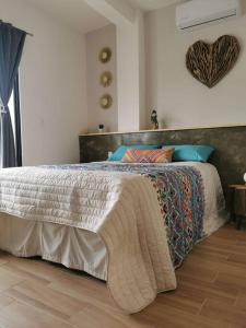 a bedroom with a bed with a blanket on it at MaaR Estudio 2, a 2 cuadras del Malecón de La Paz in La Paz