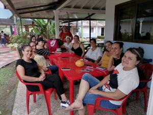 a group of people sitting at a red table at hotel palma dorada in Doradal