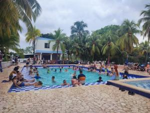a group of people in the swimming pool at a resort at hotel palma dorada in Doradal