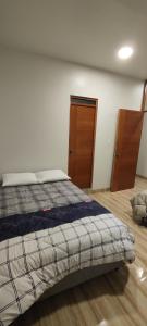 En eller flere senge i et værelse på Estancia Familiar