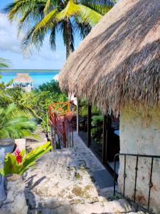 a hut on the beach with a view of the ocean at Villa Ensueño, Lagoon Private Front in Bacalar