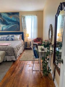 a bedroom with a bed and a table and a chair at Cozy home, King bed, 3 bedrooms,close to downtown beaches towncenter in Jacksonville