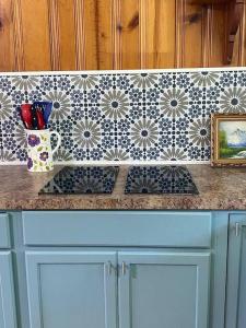 a kitchen counter with a tile backsplash and a counter top at Cozy home, King bed, 3 bedrooms,close to downtown beaches towncenter in Jacksonville