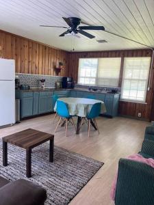 a living room with a table and a kitchen at Cozy home, King bed, 3 bedrooms,close to downtown beaches towncenter in Jacksonville