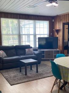 a living room with a couch and a tv at Cozy home, King bed, 3 bedrooms,close to downtown beaches towncenter in Jacksonville