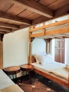 a bedroom with two bunk beds and two tables at Private Townhouse (Serenia Homestay) in San Juan