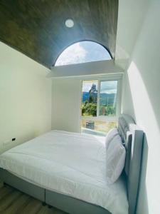 Schlafzimmer mit einem großen Bett und einem Fenster in der Unterkunft Chalet Cerinza by Malaver in Cerinza