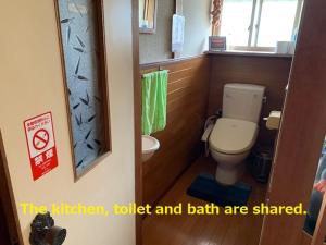 a small bathroom with a toilet and a sink at 磯ノ浦駅前ゲストハウス 月と空moon and sky in Wakayama