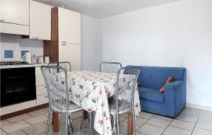 cocina con mesa y sofá azul en Gorgeous Apartment In Posada With Kitchen, en Posada