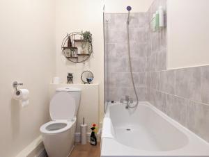 a bathroom with a toilet and a bath tub at Lovely Studio In Anfield Near Centre Free Parking in Liverpool