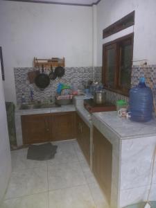 a kitchen with a sink and a counter top at joglo house karinduaji madasari in Bulakbenda