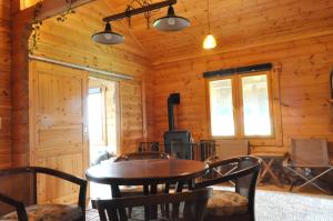 a dining room with a table and chairs in a cabin at ログコテージEco-friendly Log Cottage - be with nature in Furano