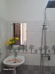 a bathroom with a sink and a mirror at Cong Man Homestay Cham Island in Hoi An