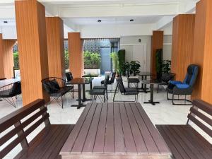 a lobby with chairs and tables in a building at Wesahh Homeplace in Khon Kaen