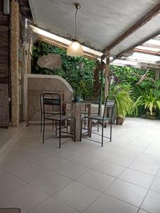 a patio with a table and chairs and plants at Wonderland Villa - Seminyak in Seminyak
