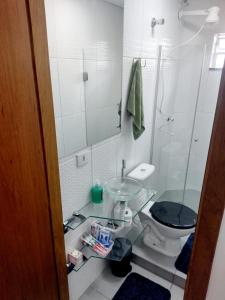 a bathroom with a toilet and a sink and a mirror at Flat Ideal para conexão 5 in Guarulhos