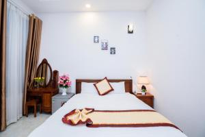 Postel nebo postele na pokoji v ubytování Tuấn An Hotel