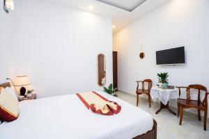Postel nebo postele na pokoji v ubytování Tuấn An Hotel