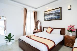 Postel nebo postele na pokoji v ubytování Tuấn An Hotel