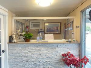 a food truck counter with a window and flowers at Robbie's Motel in Cache Creek