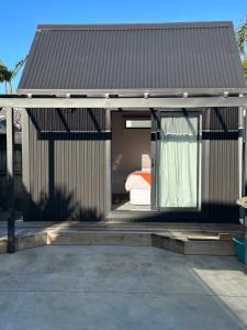 a small house with a bed inside of it at Modern Two bedroom Oasis in Whangamata