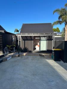 an empty parking lot in front of a house at Modern Two bedroom Oasis in Whangamata