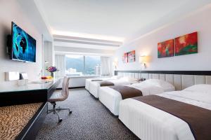 Letto o letti in una camera di Regal Riverside Hotel