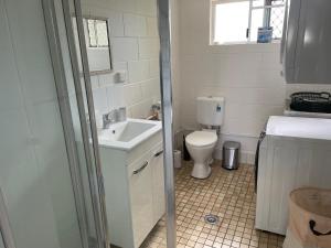 a bathroom with a sink and a toilet at Coral Reef Resort in Cairns +18 photos