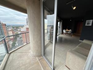 a balcony with a view of a city at Garden Point Luxury Apartments in San Miguel de Tucumán