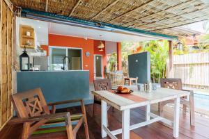 a kitchen and dining room with a table and chairs at Gecko Beach Villas in Hinkong