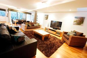 a living room with couches and a flat screen tv at Apt 8 'Aquilla' @ Bay View Centro, Dunsborough in Dunsborough