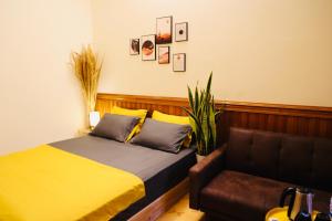 a bedroom with a bed and a couch at Homestay cạnh Lăng Bác in Hanoi