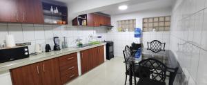 a kitchen with wooden cabinets and a counter top at EDIFICIO RENZO Apart in Tarija