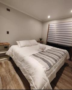 Säng eller sängar i ett rum på Hermosa cabaña amoblada las Trancas