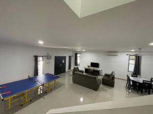 a living room with a ping pong table in it at Villa homesty Port Dickson in Port Dickson