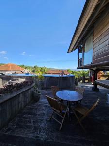 a patio with a table and chairs on a patio at I Guci Home in Munduk