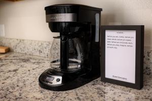 a coffee maker sitting on a counter next to a sign at Historic Apartment Downtown SA in San Antonio