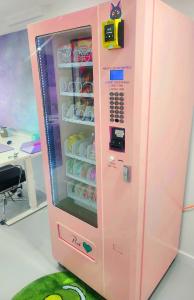 a pink vending machine with drinks inside of it at Dreamhouse in Melbourne