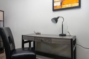 a desk with a lamp and a chair in a room at Historic Apartment Downtown SA in San Antonio