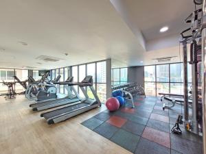 a gym with treadmills and exercise equipment in a building at Citrus Suites Sukhumvit 6 by Compass Hospitality in Bangkok